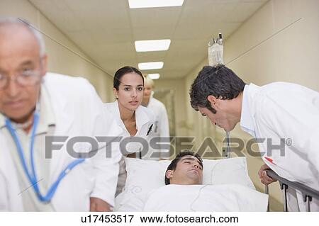 Doctors rushing patient down hallway View Large Photo Image Stock Photo - Doctors rushing patient down hallway. Fotosearch