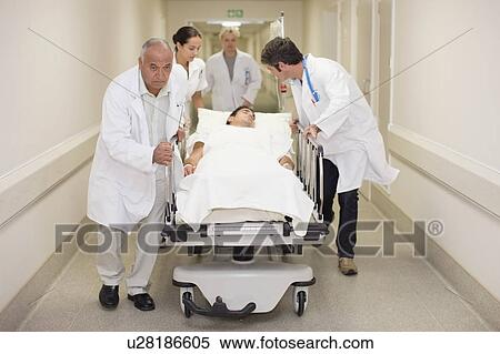 Doctors rushing patient down hallway View Large Photo Image Stock Photography - Doctors rushing patient down hallway. Fotosearch