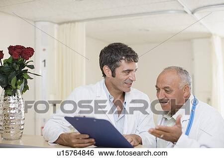 Stock Photograph - Doctors talking in hospital. Fotosearch