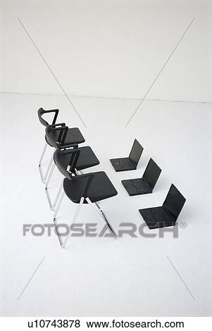 Empty chairs with laptops in office View Large Photo Image Stock Photo - Empty chairs with laptops in office. Fotosearch