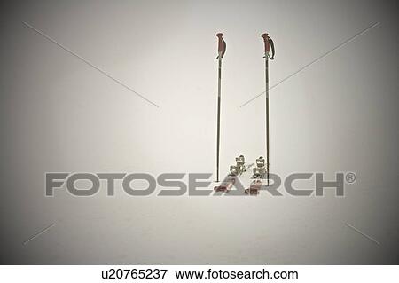 Stock Photo - Empty skis and poles in snow. Fotosearch