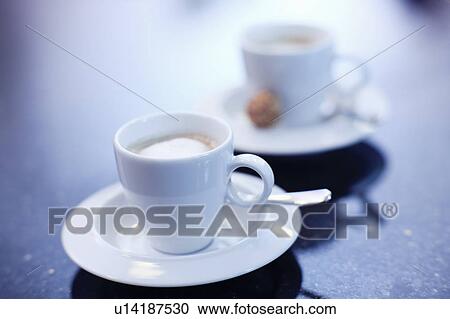 Stock Image - Espresso cups on office desk. Fotosearch