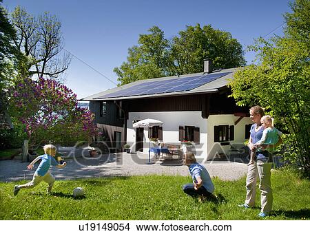 Picture - Family at home with solar panel. Fotosearch