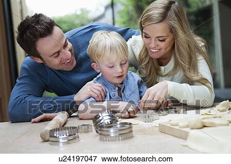 Family baking together in kitchen View Large Photo Image Stock Photo - Family baking together in kitchen. Fotosearch