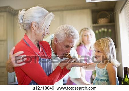 Stock Photo - Family cooking together in kitchen. Fotosearch