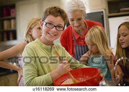 Stock Photo - Family cooking together in kitchen. Fotosearch