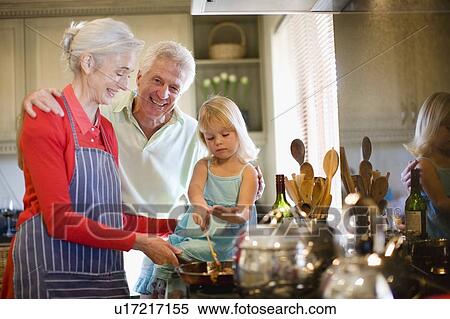 Family cooking together in kitchen View Large Photo Image Stock Photography - Family cooking together in kitchen. Fotosearch