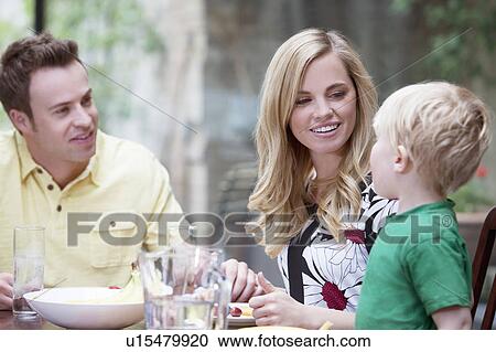 Family eating a meal together at home View Large Photo Image Stock Image - Family eating a meal together at home. Fotosearch