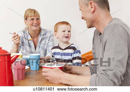 Family laughing at breakfast View Large Photo Image Stock Image - Family laughing at breakfast. Fotosearch
