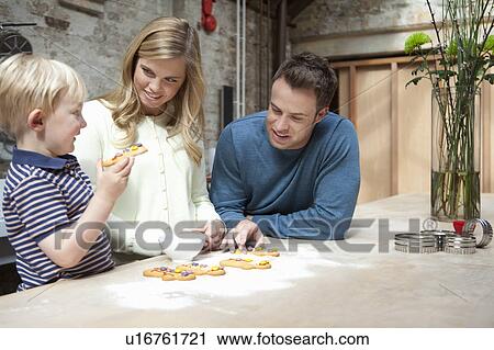 Family making cookies in kitchen View Large Photo Image Stock Image - Family making cookies in kitchen. Fotosearch