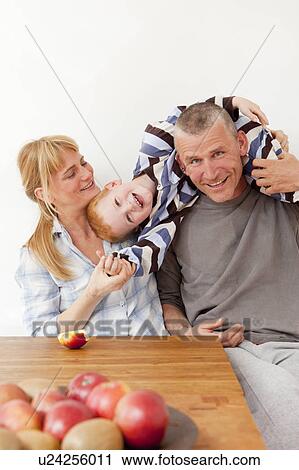 Family playing at table together View Large Photo Image Stock Image - Family playing at table together. Fotosearch