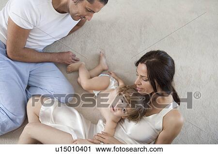 Stock Image - Family playing on floor. Fotosearch