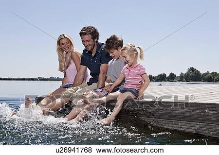 Family playing together on dock View Large Photo Image Stock Photo - Family playing together on dock. Fotosearch