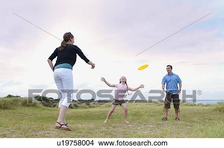 Picture - Family playing with frisbee outdoors. Fotosearch