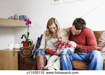 Stock Photo - Family playing with toy together. Fotosearch