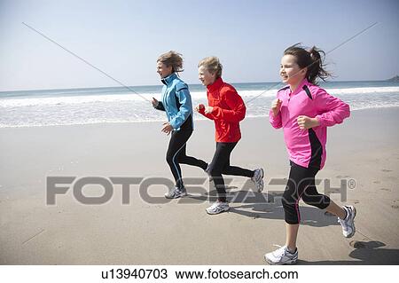 Family running on beach View Large Photo Image Stock Image - Family running on beach. Fotosearch