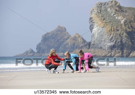 Family running together on beach View Large Photo Image Stock Photography - Family running together on beach. Fotosearch