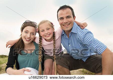Family smiling together outdoors View Large Photo Image Stock Image - Family smiling together outdoors. Fotosearch