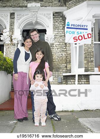 Family standing outside new home View Large Photo Image Stock Photograph - Family standing outside new home. Fotosearch
