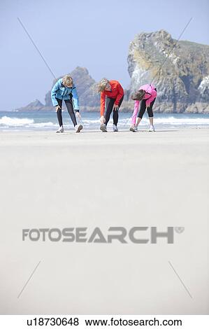Family stretching together on beach View Large Photo Image Stock Photo - Family stretching together on beach. Fotosearch