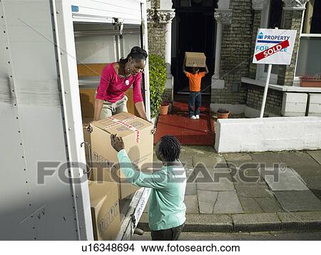 Family unpacking boxes from moving van View Large Photo Image Picture - Family unpacking boxes from moving van. Fotosearch