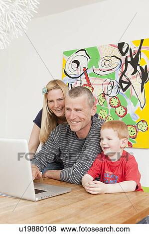 Family using laptop together View Large Photo Image Stock Photo - Family using laptop together. Fotosearch