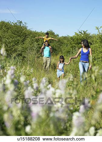 Family walking in field of flowers View Large Photo Image Stock Photo - Family walking in field of flowers. Fotosearch