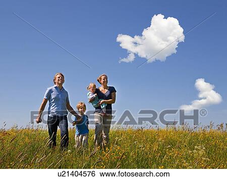 Family walking in field of flowers View Large Photo Image Stock Photograph - Family walking in field of flowers. Fotosearch