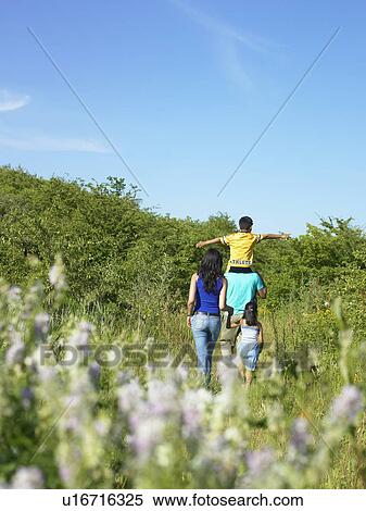 Family walking in field of flowers View Large Photo Image Stock Photography - Family walking in field of flowers. Fotosearch