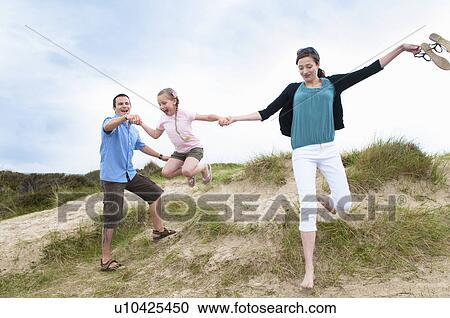 Family walking together on beach View Large Photo Image Stock Image - Family walking together on beach. Fotosearch