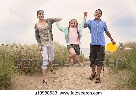 Family walking together on beach View Large Photo Image Stock Image - Family walking together on beach. Fotosearch
