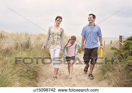 Family walking together on beach View Large Photo Image Stock Image - Family walking together on beach. Fotosearch