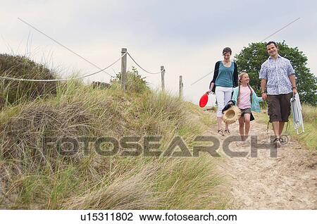 Family walking together on beach View Large Photo Image Stock Image - Family walking together on beach. Fotosearch
