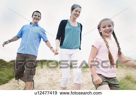 Family walking together on beach View Large Photo Image Stock Photo - Family walking together on beach. Fotosearch