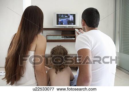 Family watching television together View Large Photo Image Stock Photo - Family watching television together. Fotosearch