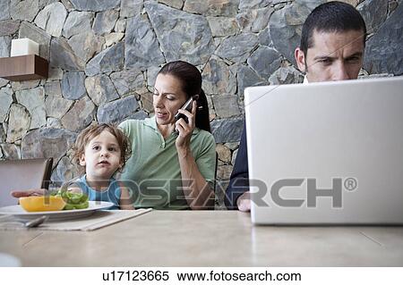 Family working at breakfast table View Large Photo Image Stock Photography - Family working at breakfast table. Fotosearch