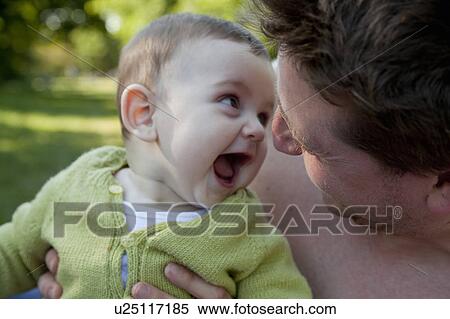 Stock Photography - Father and baby son playing outdoors. Fotosearch