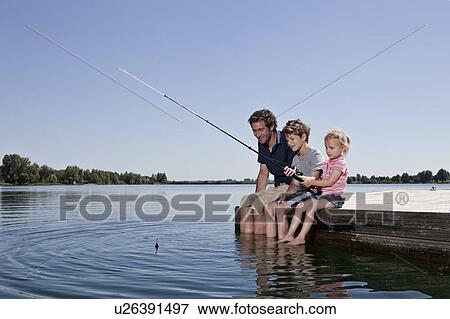 Father and children fishing on dock View Large Photo Image Stock Photo - Father and children fishing on dock. Fotosearch