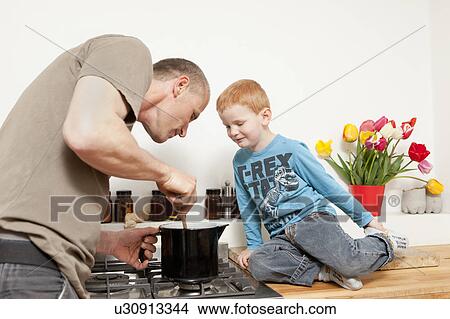 Father and son cooking in kitchen View Large Photo Image Picture - Father and son cooking in kitchen. Fotosearch