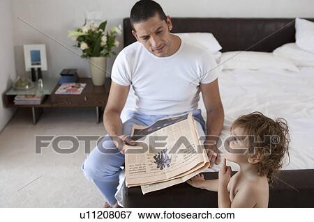 Stock Photo - Father and son in bedroom. Fotosearch