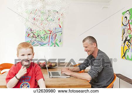 Father and son in dining room View Large Photo Image Stock Image - Father and son in dining room. Fotosearch