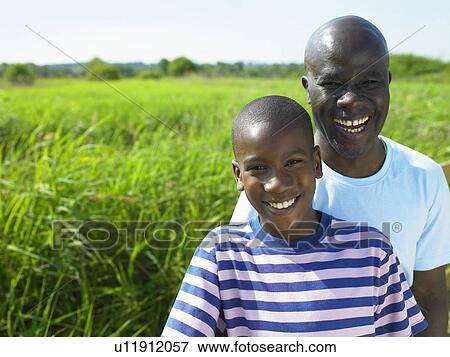 Father and son in field together View Large Photo Image Stock Photo - Father and son in field together. Fotosearch