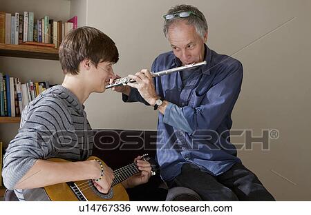 Stock Photograph - Father and son playing music together. Fotosearch