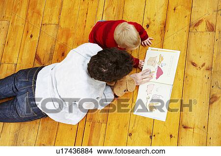 Father and son reading together View Large Photo Image Picture - Father and son reading together. Fotosearch