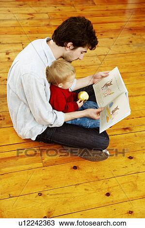 Father and son reading together View Large Photo Image Stock Image - Father and son reading together. Fotosearch