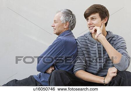Stock Photograph - Father and son sitting together. Fotosearch