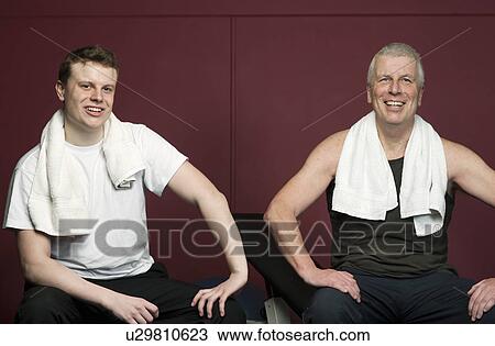 Father and son with towels in gym View Large Photo Image Stock Image - Father and son with towels in gym. Fotosearch