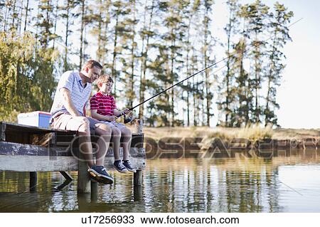 Father fishing with son in lake View Large Photo Image Stock Image - Father fishing with son in lake. Fotosearch
