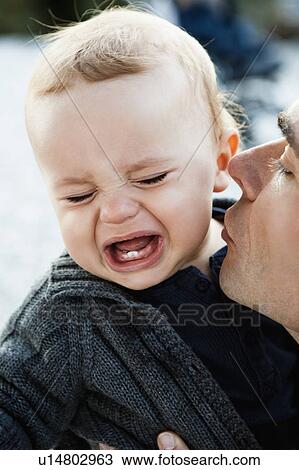 Father kissing crying baby View Large Photo Image Stock Image - Father kissing crying baby. Fotosearch
