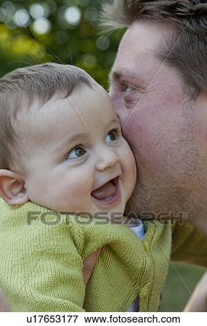 Father kissing laughing baby boy View Large Photo Image Stock Photo - Father kissing laughing baby boy. Fotosearch
